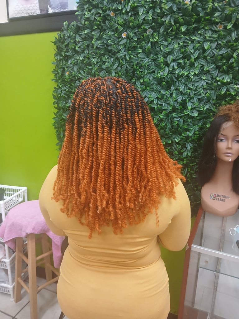 Close-up of professional African hair braiding with detailed parting.